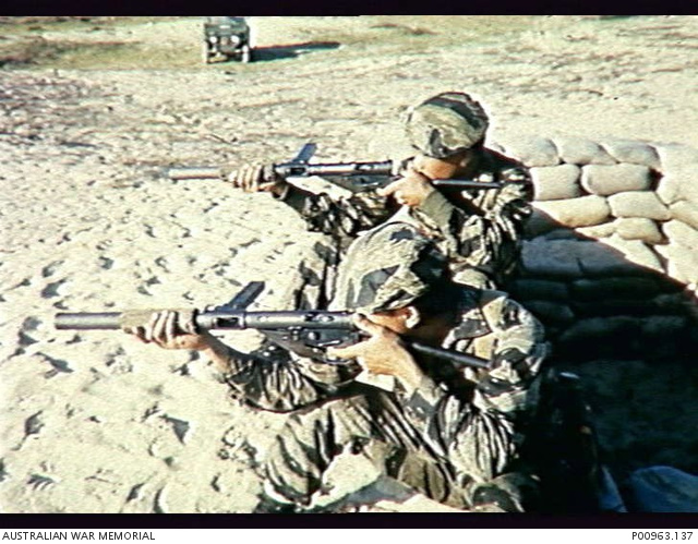 South Vietnam. c. 1966. Two hand-picked Vietnamese scouts of MGF-759 firing silenced British Sten Mk 5 machine guns on a range in Corps I area.