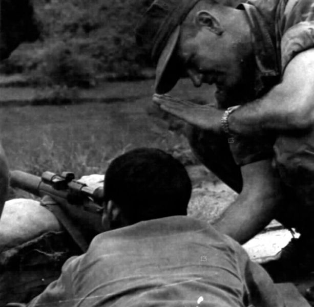 A U.S. Marine works with a South Vietnamese Popular Force recruit and his M1D rifle.