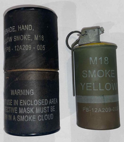 A Yellow M18 colored smoke grenade with it's carboard container tube.