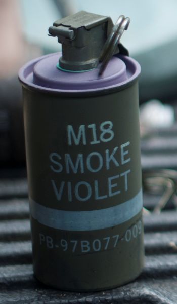 A member of the 11th Civil Engineer Squadron Explosive Ordnance Disposal unit prepares M18 smoke grenades for training here, April 17. (U.S. Air Force photo/Staff Sgt. Robert Cloys) Image cropped to focus on M18 grenade.